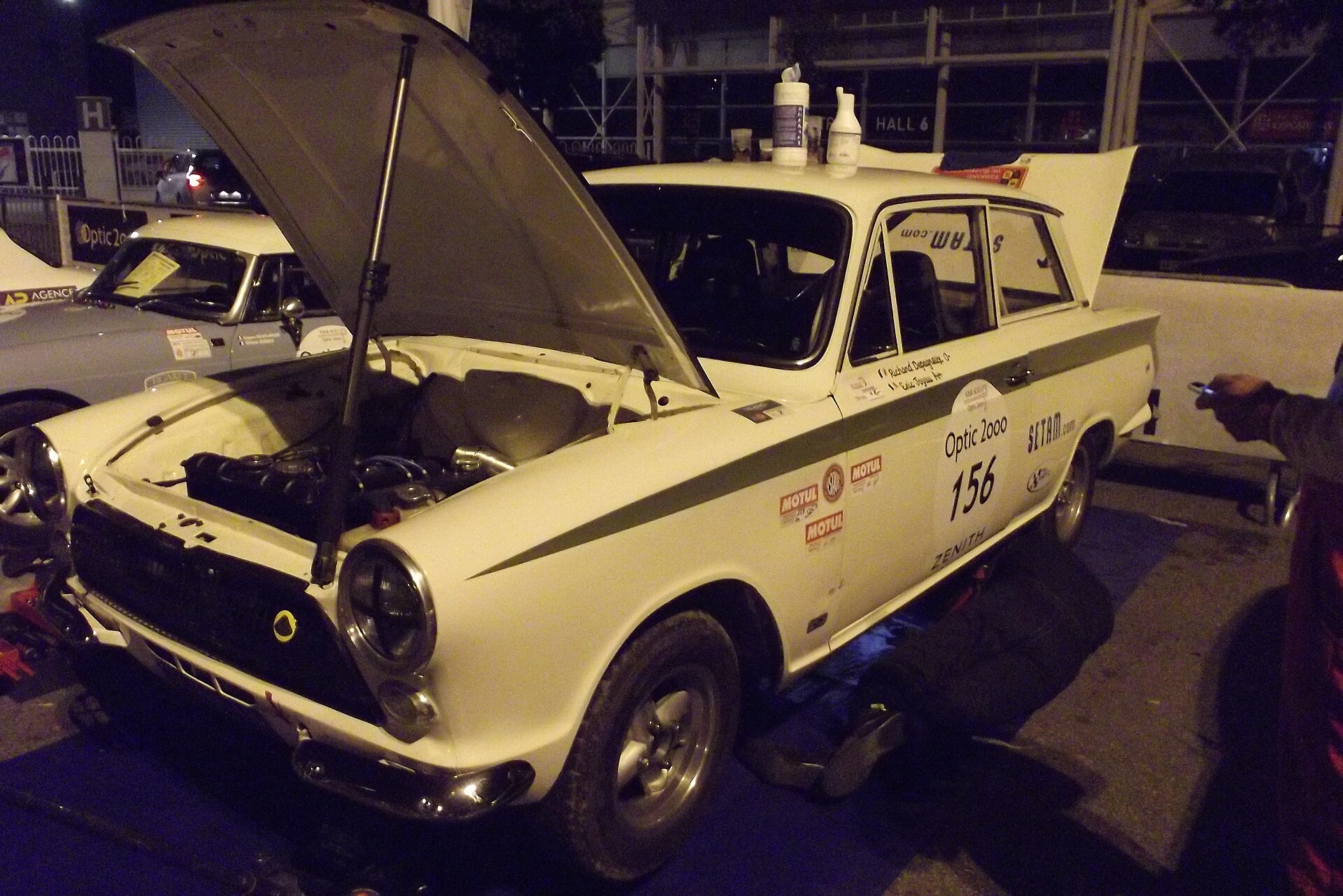 1965 Ford Lotus Cortina Mk1 photographed at the Tour Auto 2015 in Toulouse, showing the distinctive Ermine White paintwork and Sherwood Green flash