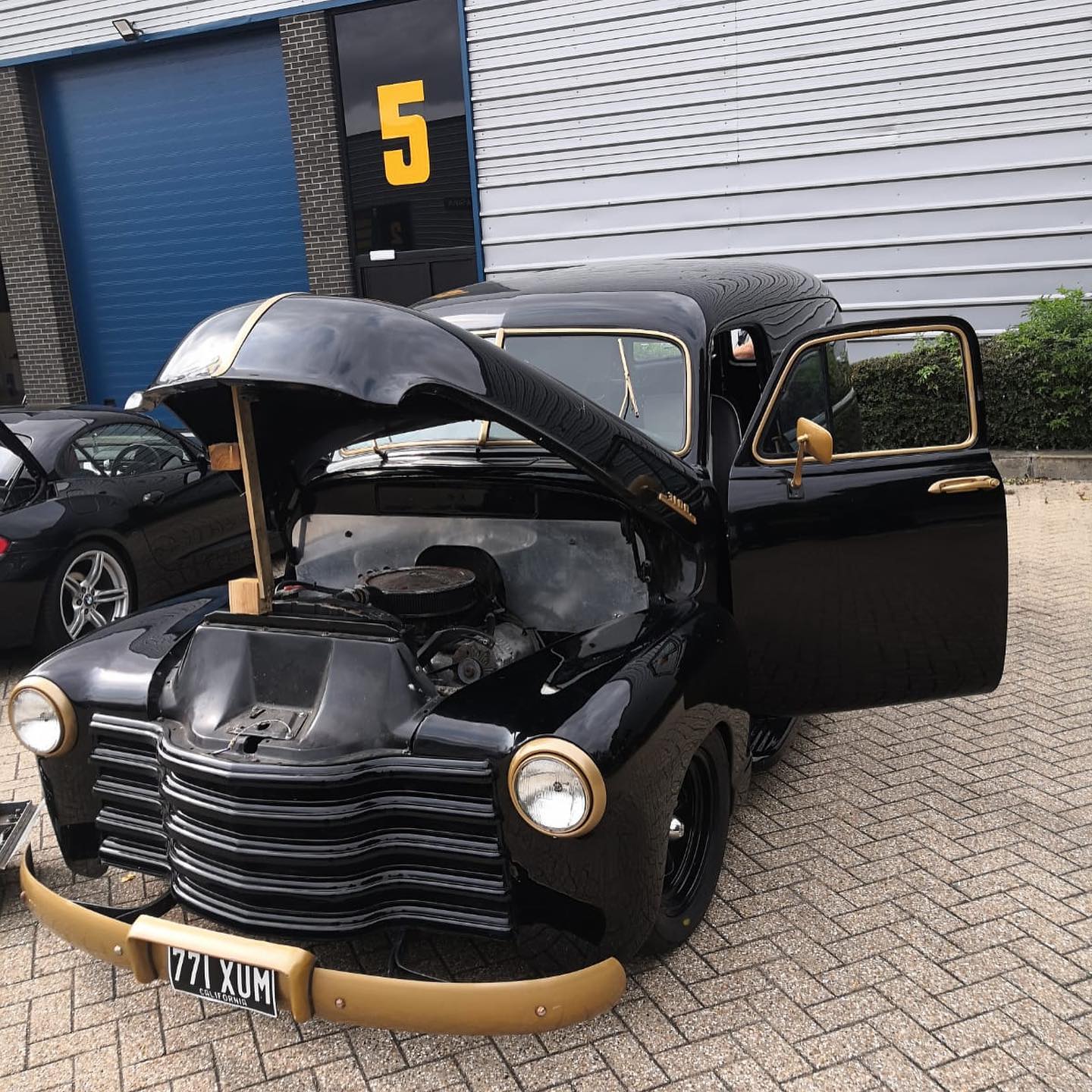 Chevrolet 3100 Panel Van front three-quarter view with hood open showing completed bodywork