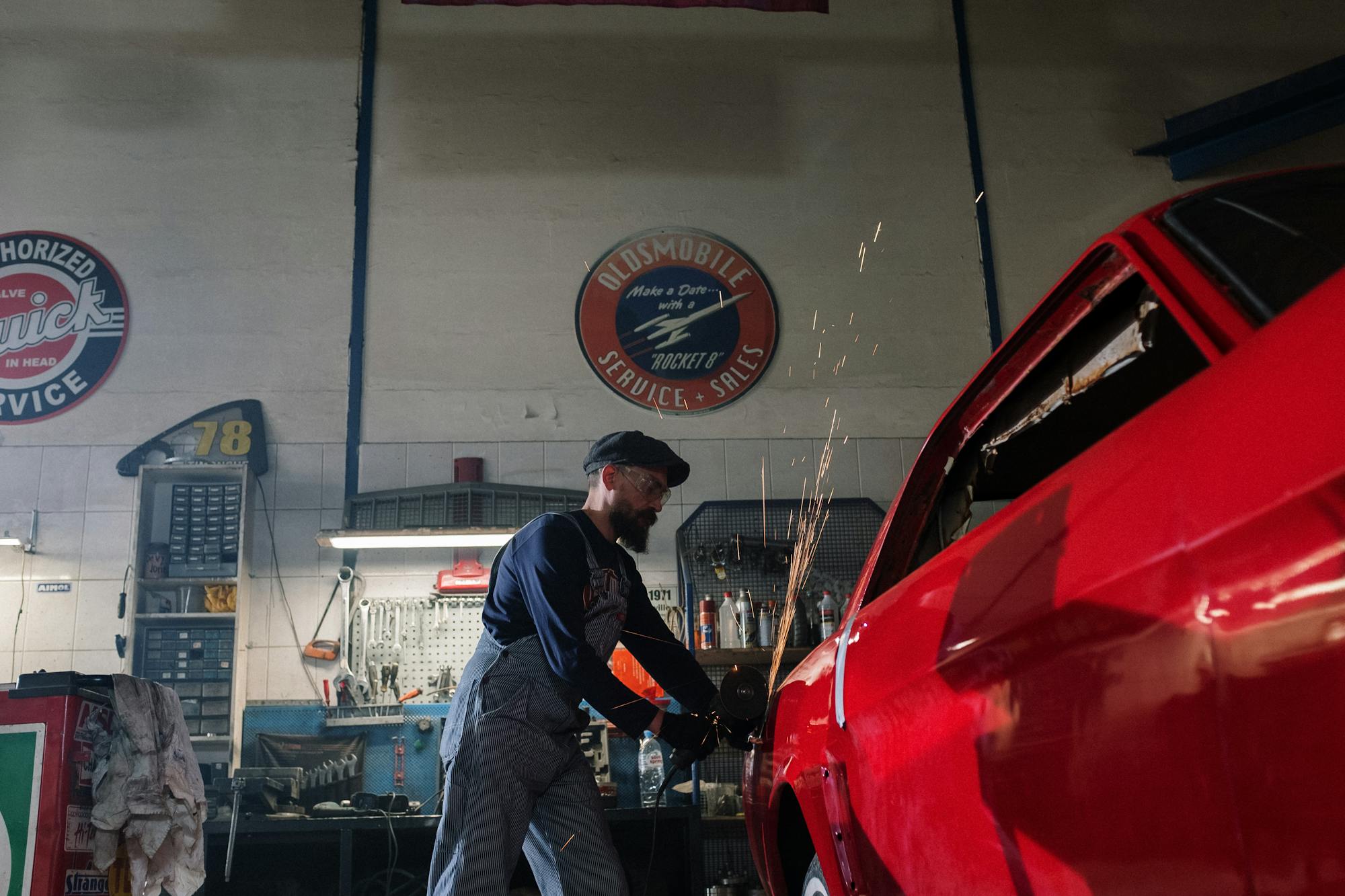 Classic Ford restoration welding — sparks flying as a new panel section is welded in to replace rotten metal