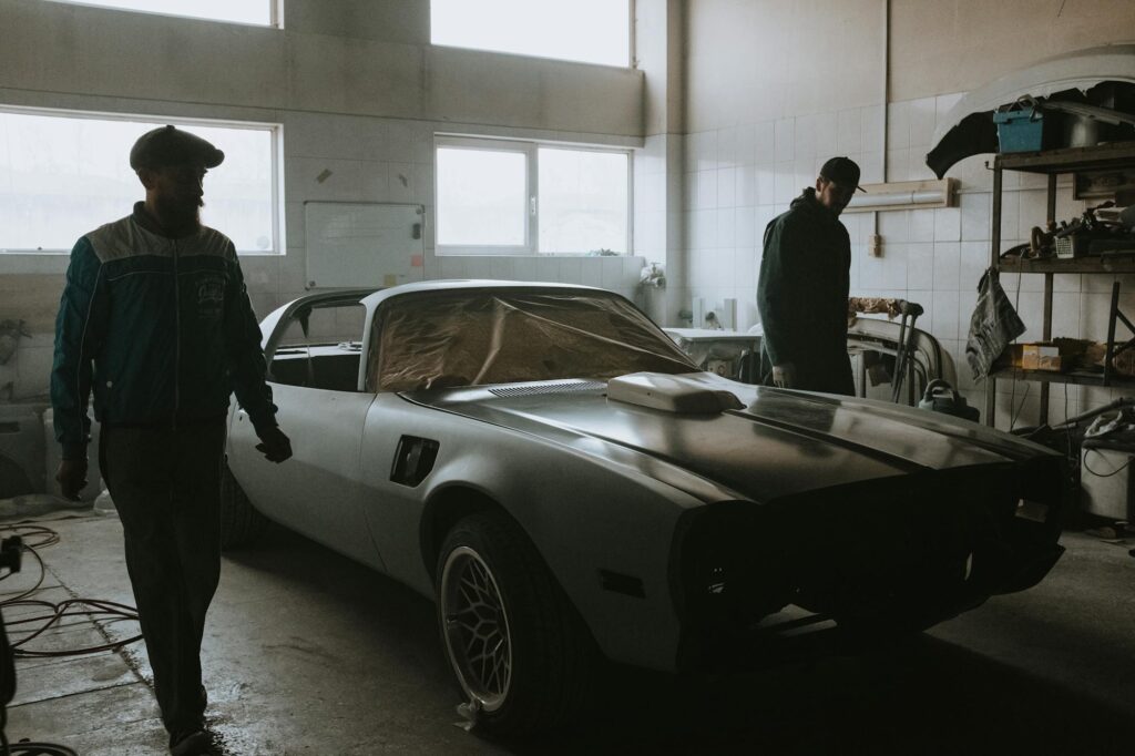 Classic Ford restoration in progress — vintage car stripped back to bare metal in a working bodyshop