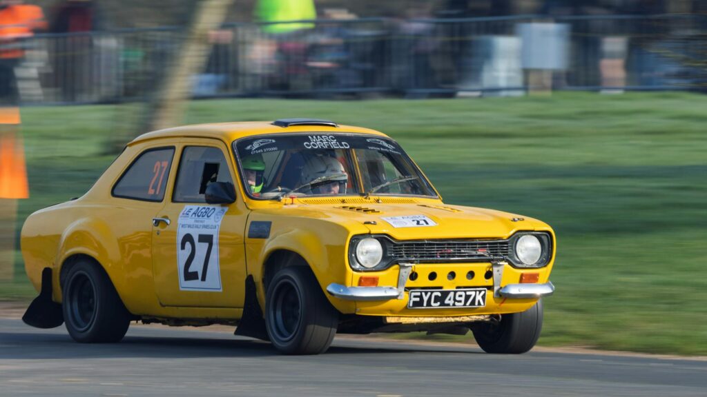 Yellow Ford Escort RS Mk2 rally car in action at Weston Park — the rally pedigree that defined the RS line