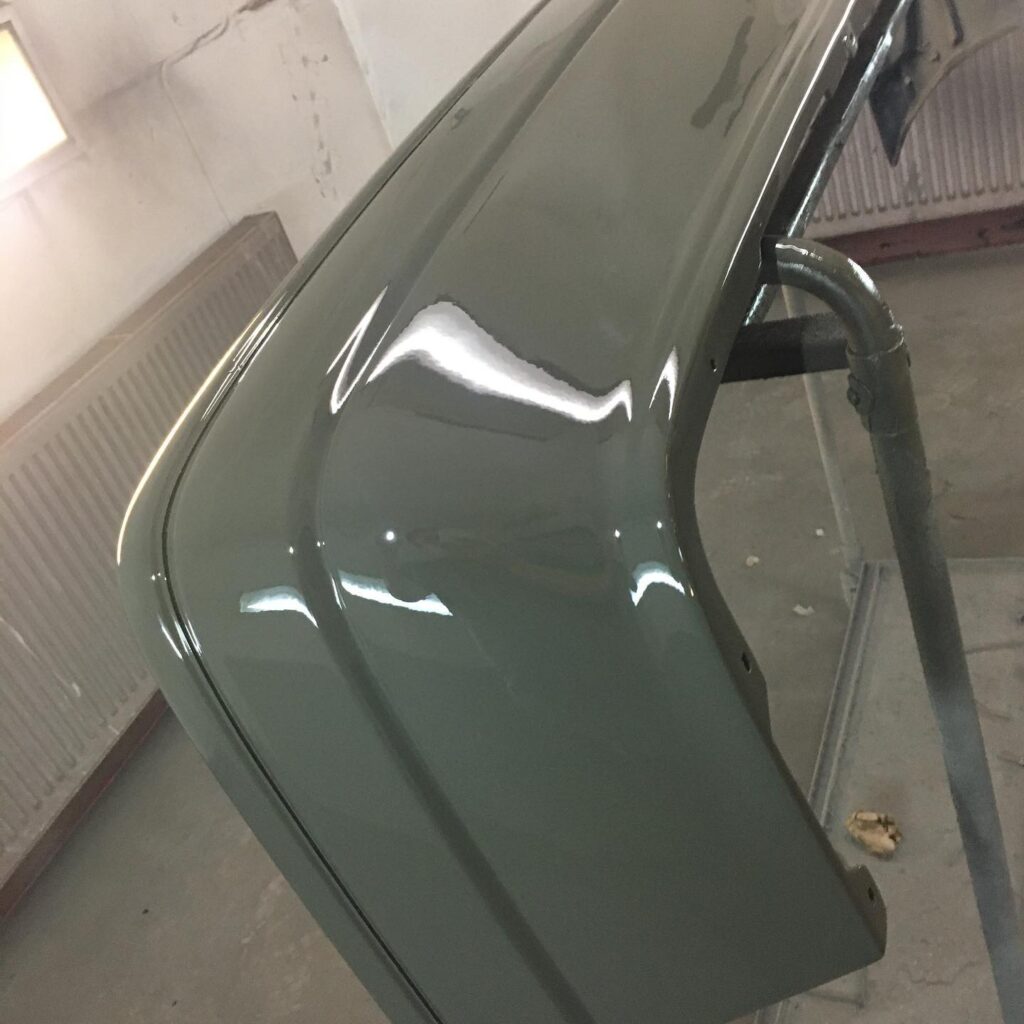 Freshly sprayed green bumper with mirror finish, respray near Milton Keynes