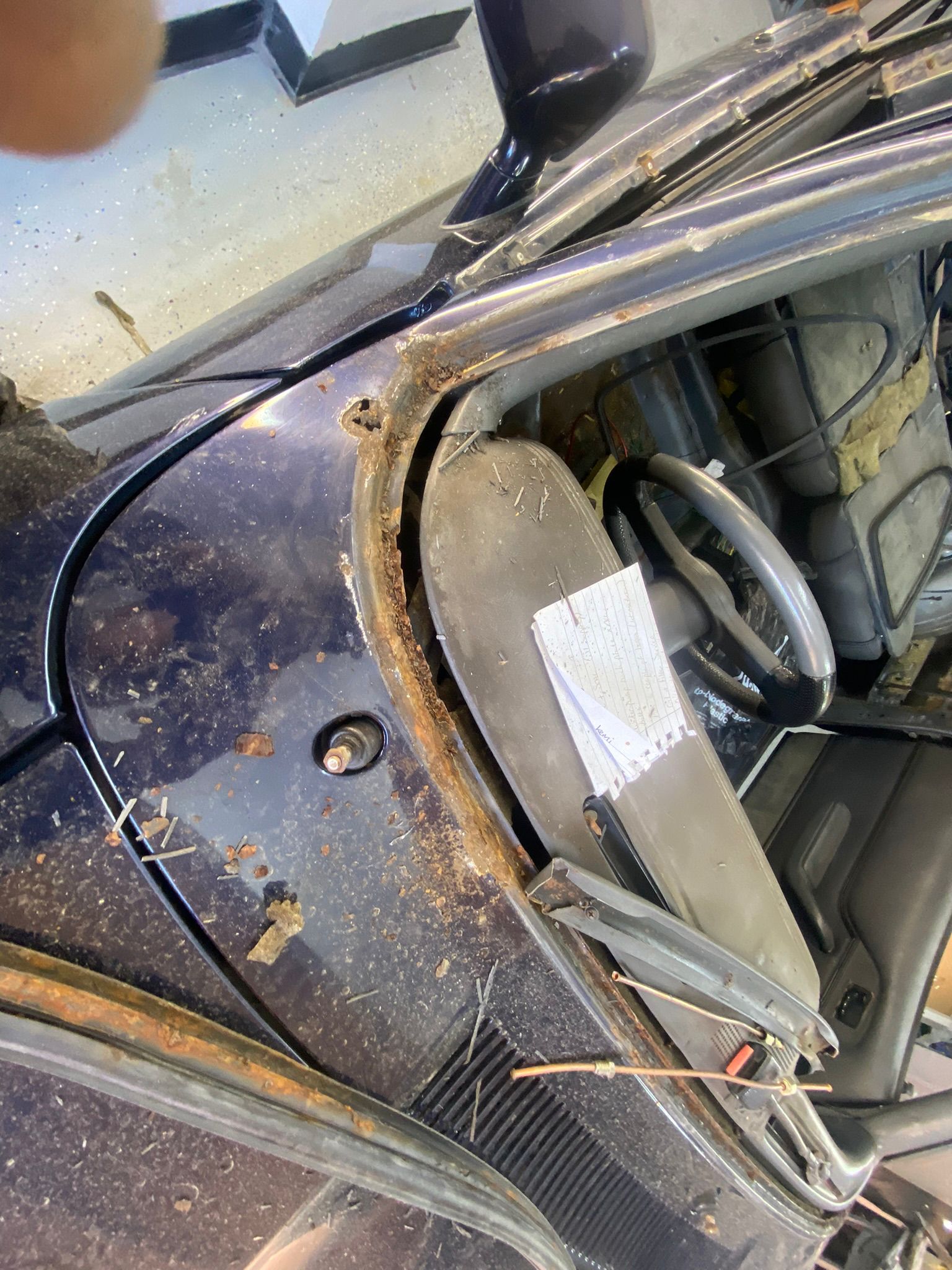 Ford Capri 2.8i Brooklands windscreen area showing heavy rust damage around scuttle panel before restoration