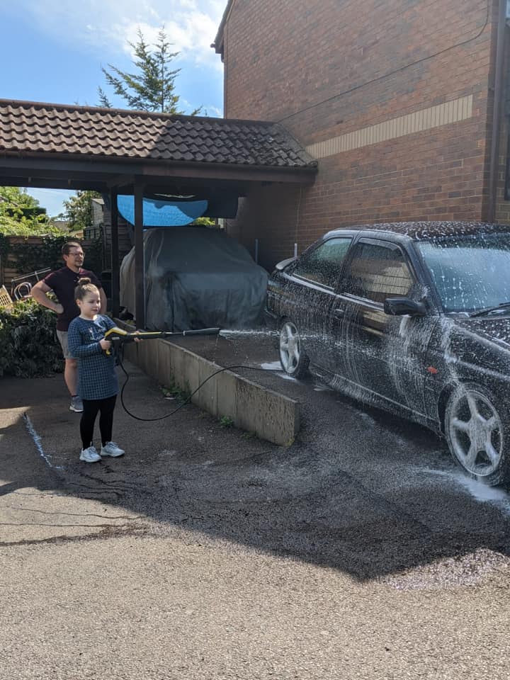Ford Escort GTI being pressure washed on driveway – Alex Cox's daily driver near Milton Keynes