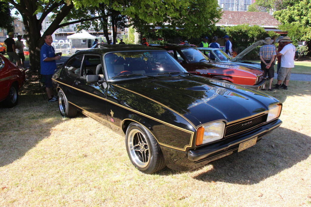 1975 Ford Capri Mk II JPS — black with gold pinstriping echoing the JPS Lotus Formula 1 livery