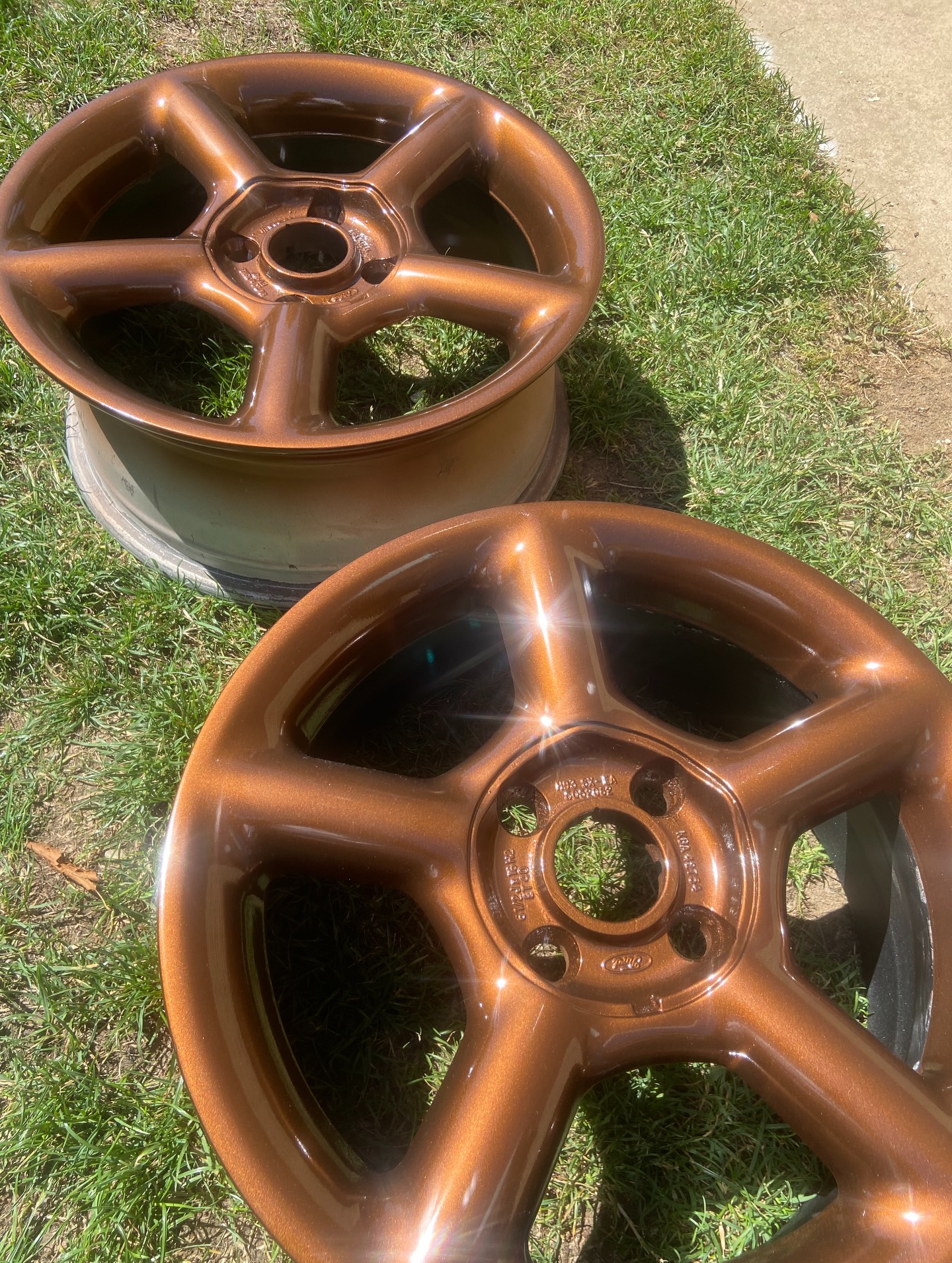 Close-up of freshly sprayed bronze alloy wheel showing metallic flake detail