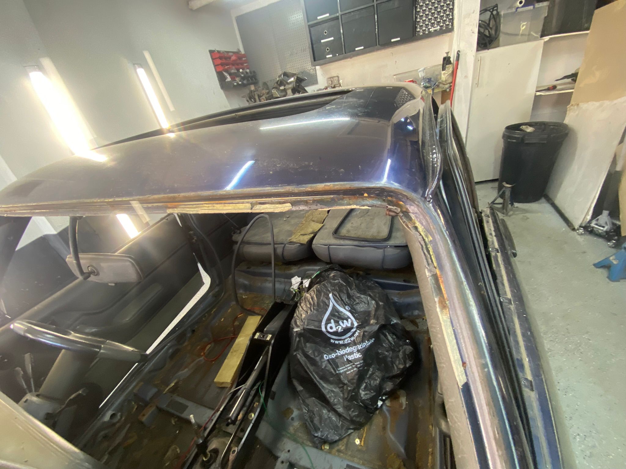 Severe structural rust along the top of a classic Ford Capri windscreen surround — hidden corrosion under the rubber seal