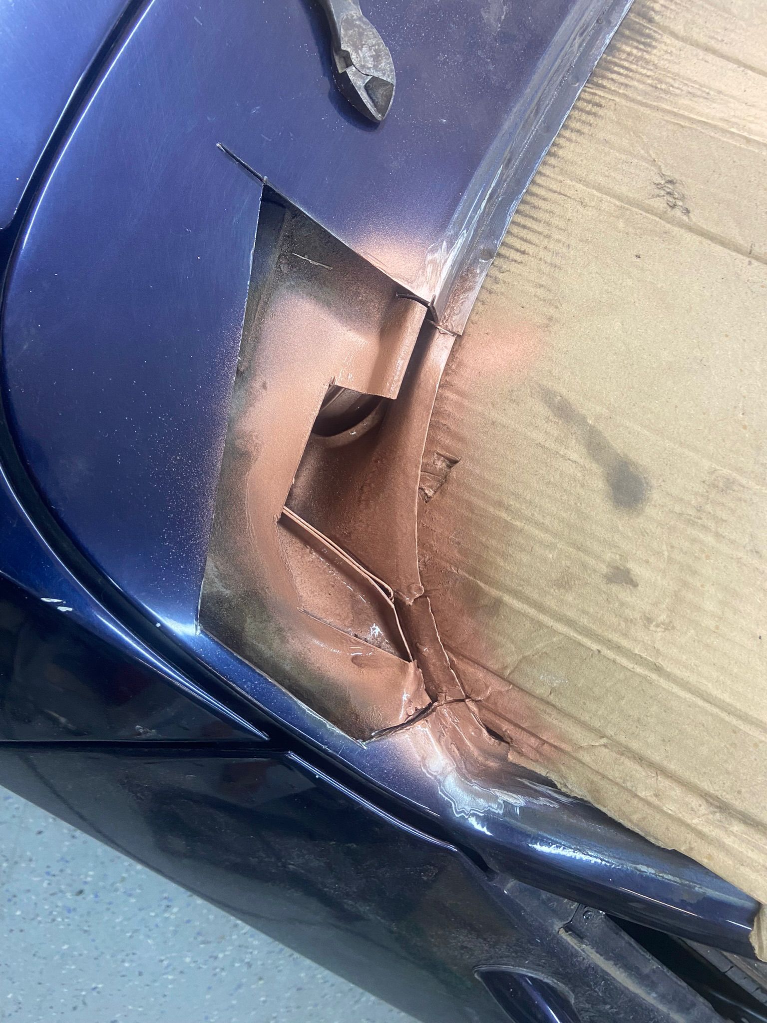 Rusted section cut out from a car panel during repair