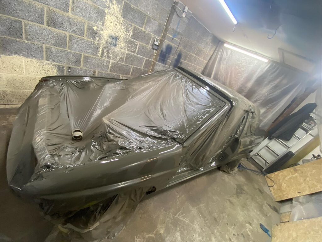 Car masked up and ready for paint in spray booth at Top Touch Coachworks, Wicken