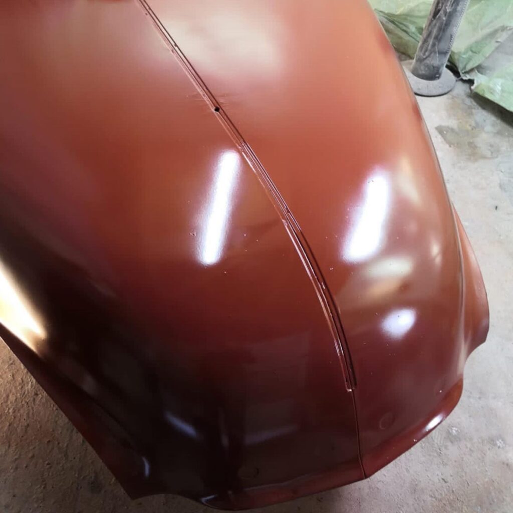 Bonnet freshly sprayed deep maroon showing mirror-like gloss finish