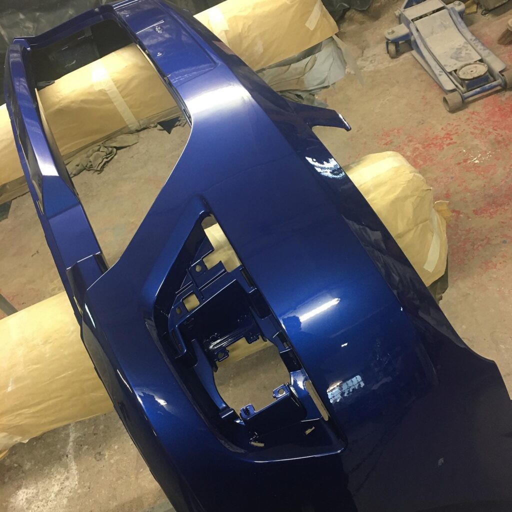 Front bumper freshly sprayed metallic blue, bumper respray near Milton Keynes