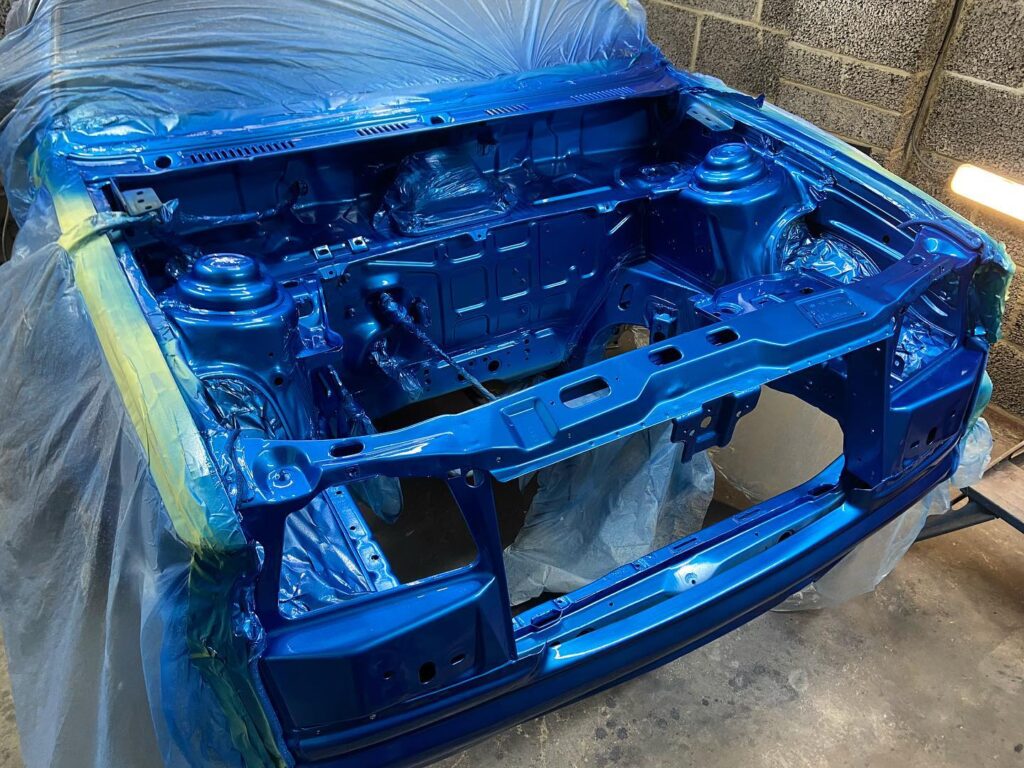 Engine bay freshly sprayed metallic blue during full respray at Top Touch Coachworks near Milton Keynes