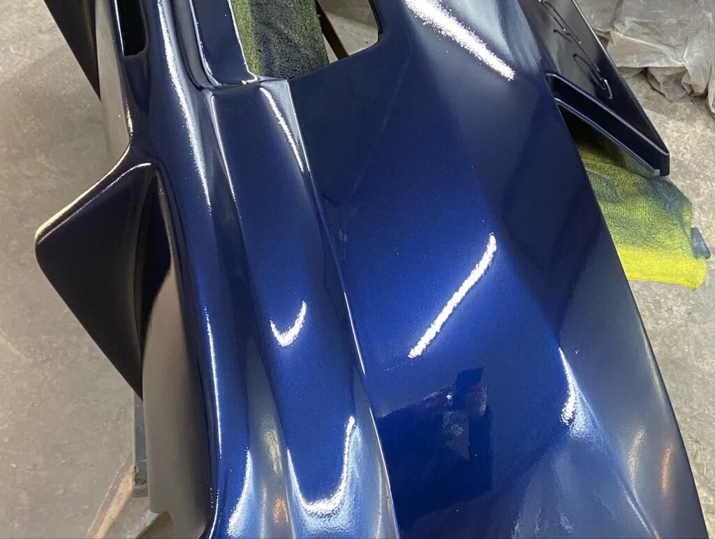 Close-up of bumper showing deep metallic blue finish, custom respray near Buckingham