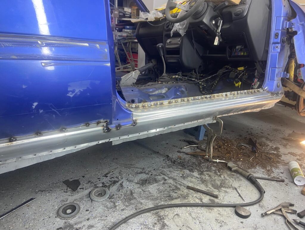 Sill replacement on a blue car with plug welds visible, welding by Top Touch Coachworks near Milton Keynes