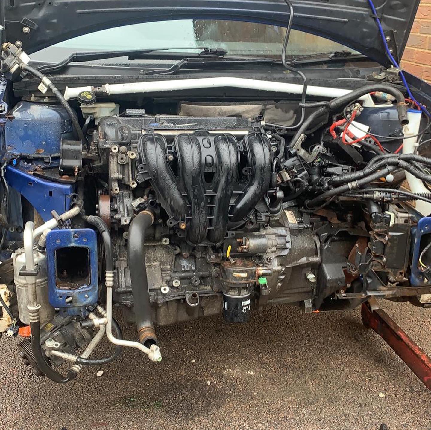 Blue Ford Fiesta ST with bonnet up showing engine bay and ST badge on grille