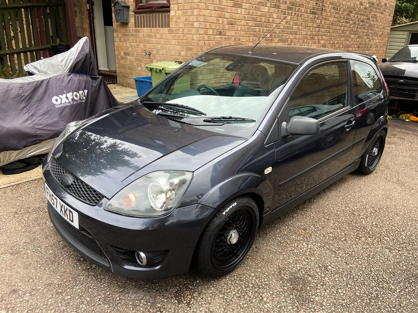 Dark grey Ford Fiesta Zetec S Mk6 with black alloys and Toyo tyres — modified Ford project