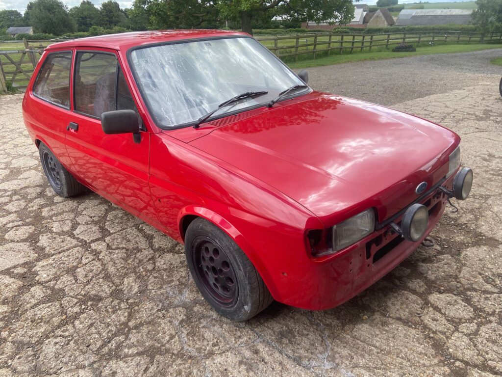 Red Ford Fiesta Mk2 front three-quarter view after rust repair and respray at Top Touch Coachworks near Milton Keynes