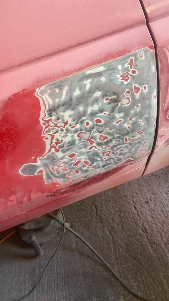 Ford Fiesta Mk2 lower door and quarter sanded back and feathered, prepped for primer and paint