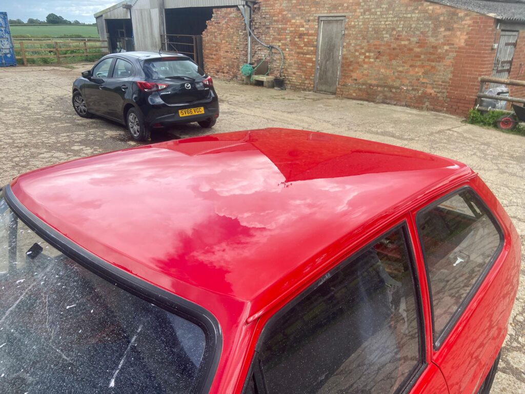 Ford Fiesta Mk2 roof with faded oxidised original paint alongside a fresh painted section before respray